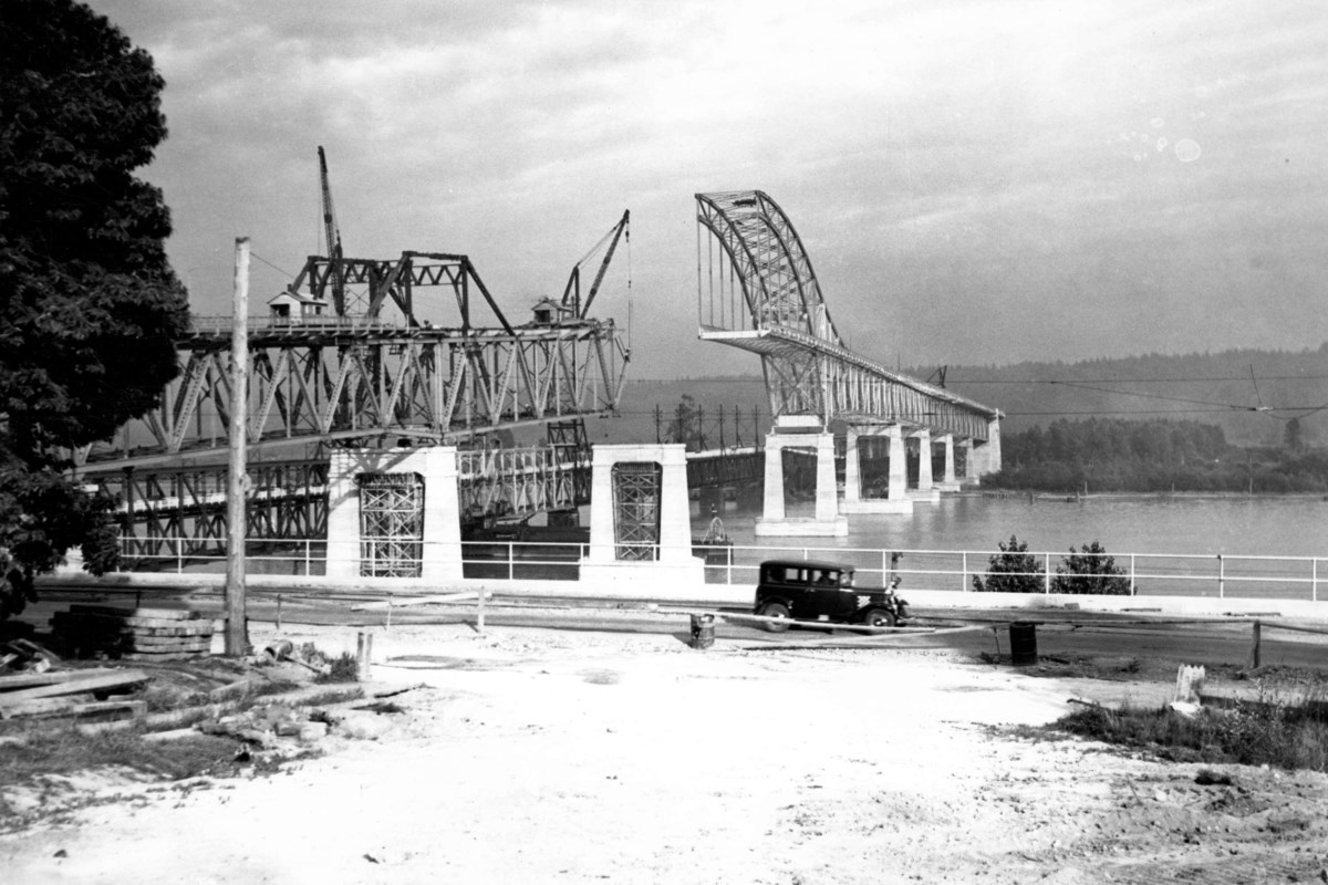 Archival photos trace the Pattullo Bridge’s construction as the central span’s orange arch is removed