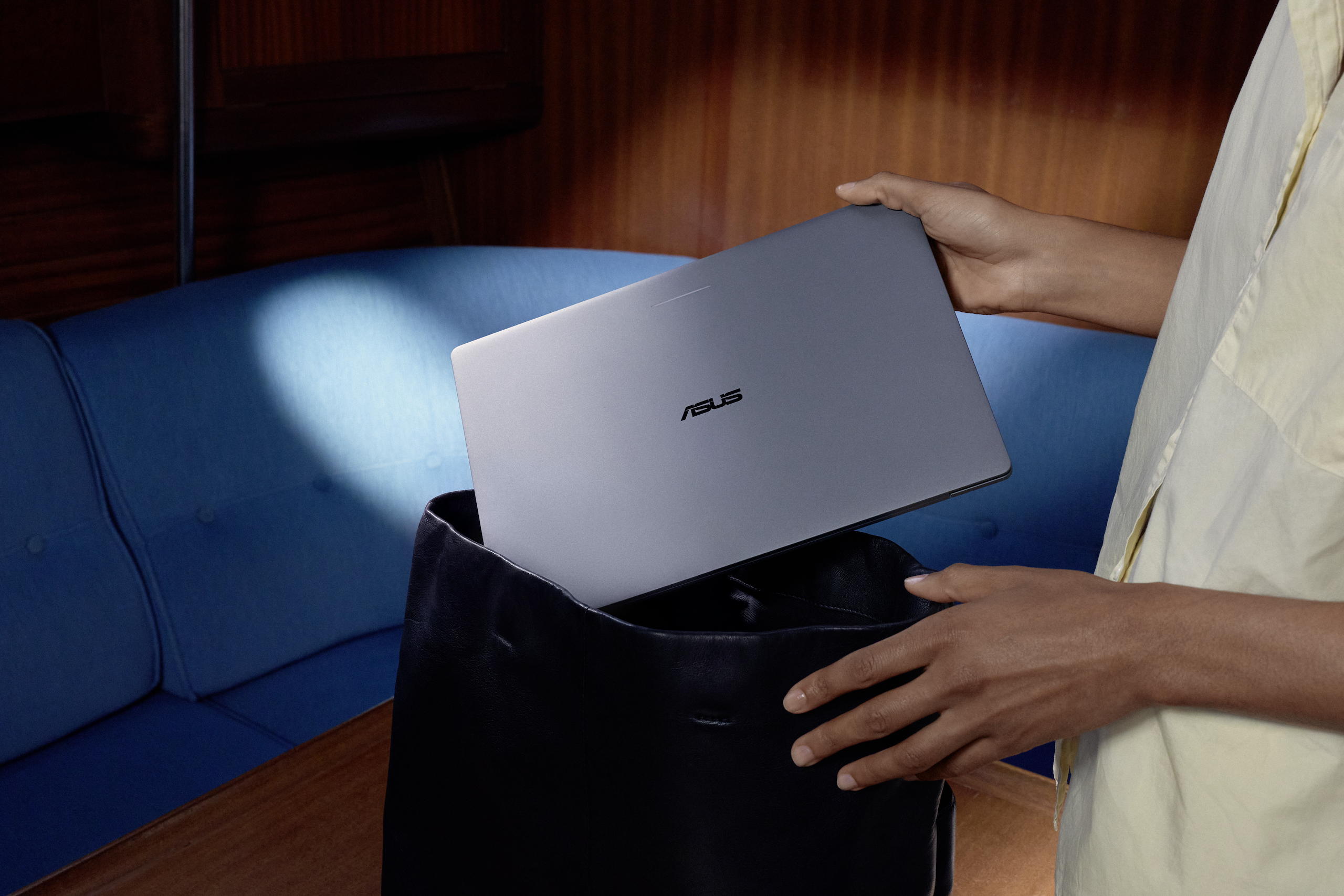 ASUS Googlebook 14 being placed into a shoulder bag